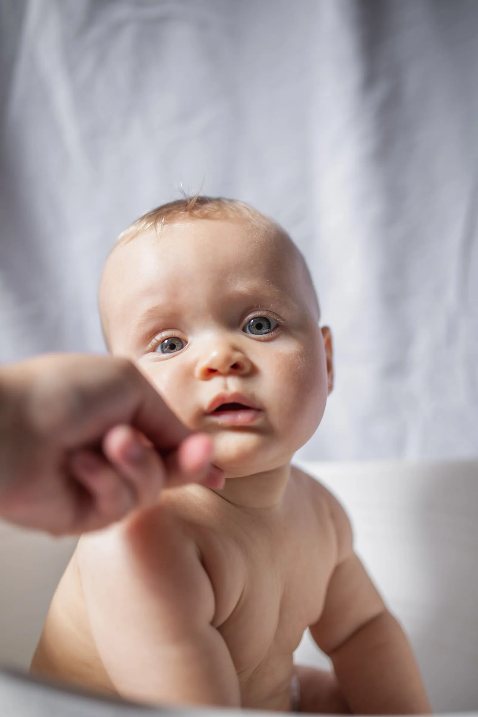 A baby boy holding onto his mother’s finger, one of Brittany’s first photos